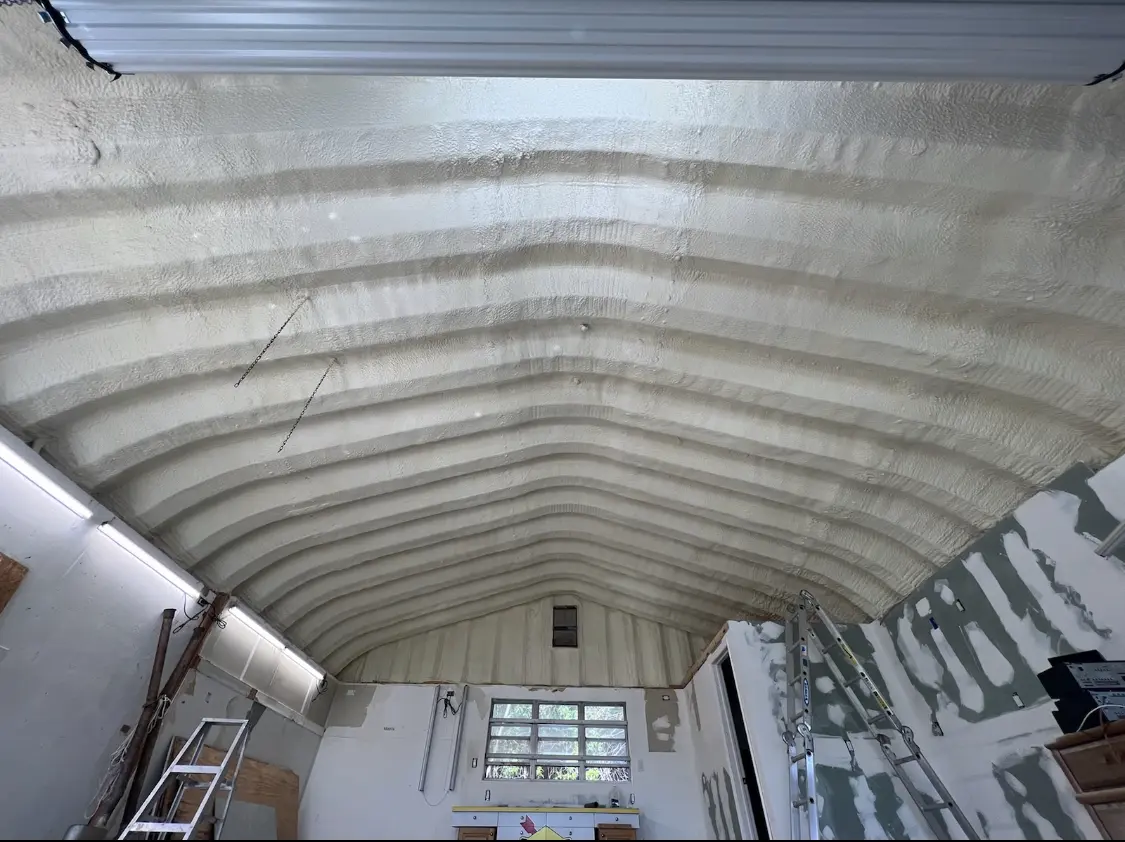 Spray polyurethane foam applied to the underside of a metal roof deck in Crookston